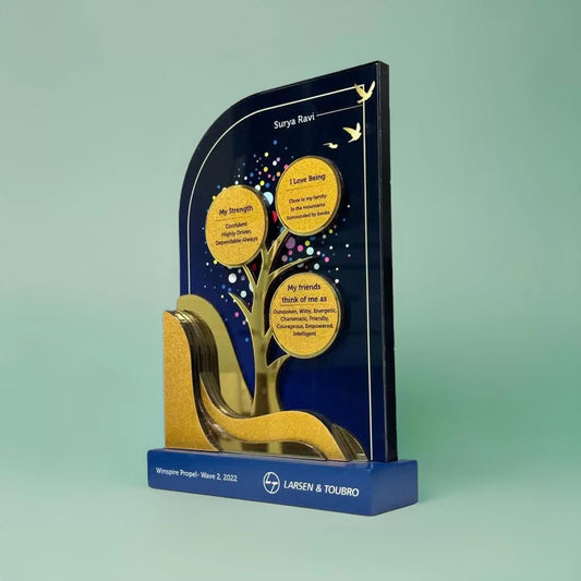A blue colored recognition trophy with a golden tree with circles at the end of branches