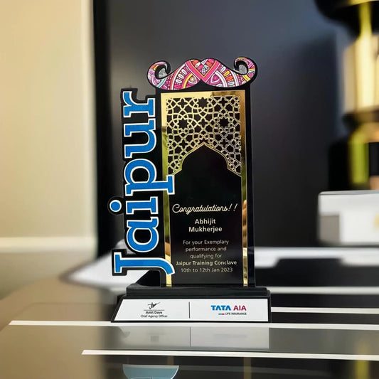 Jaipur themed trophy featuring a colorful mustache, black background and golden design